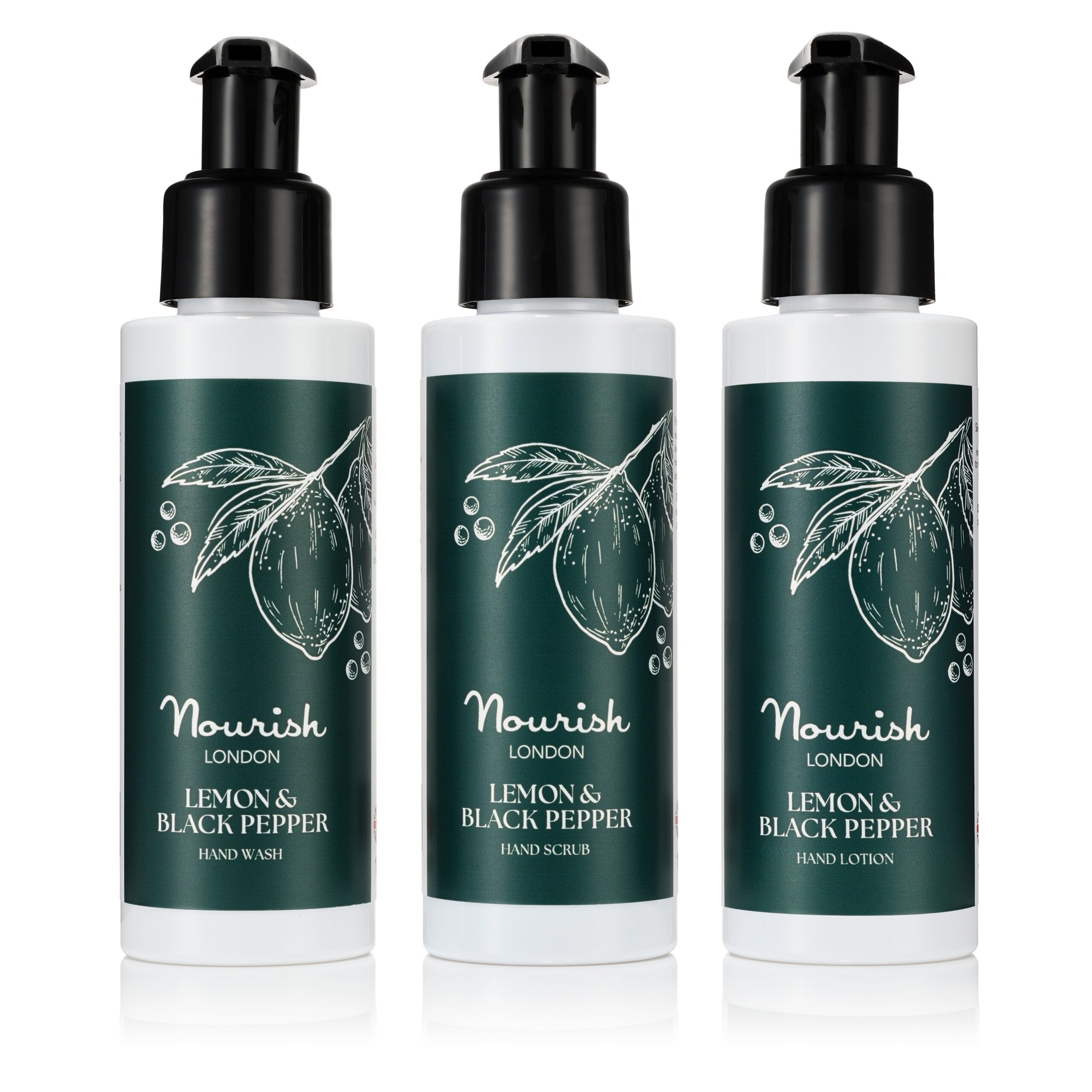 Three white bottles with black pump tops and green labels containing hand wash, hand scrub, and hand lotion